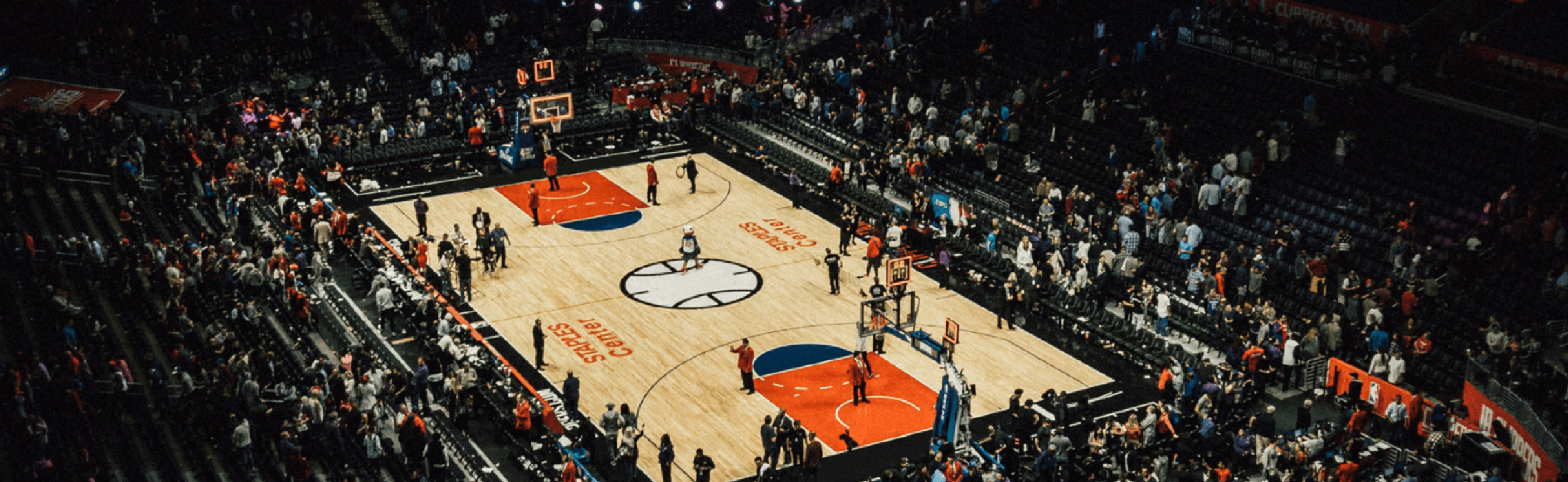 Aerial view of basketball court at with crowd in stands 